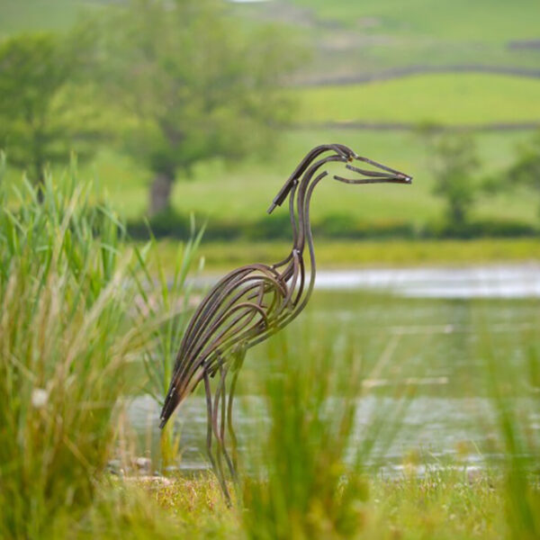 River Heron Wildlife Sculpture standing by river watching for food
